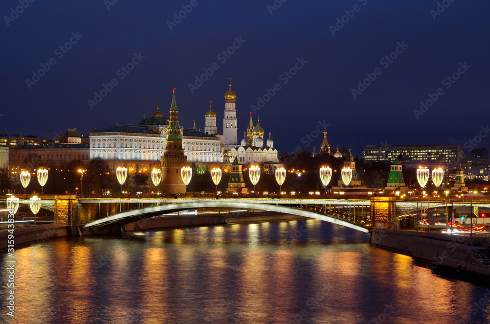 Night view of the Moscow Kremlin and the Big Stone bridge with festive new year illumination. Moscow, Russia