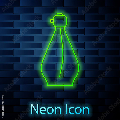 Glowing neon line Perfume icon isolated on brick wall background. Vector Illustration