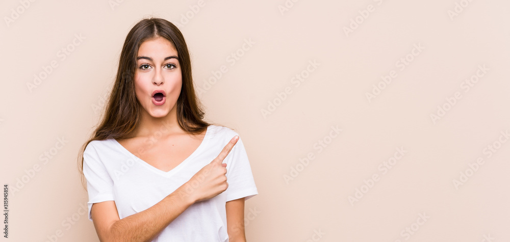 Fototapeta premium Young caucasian woman posing isolated pointing to the side