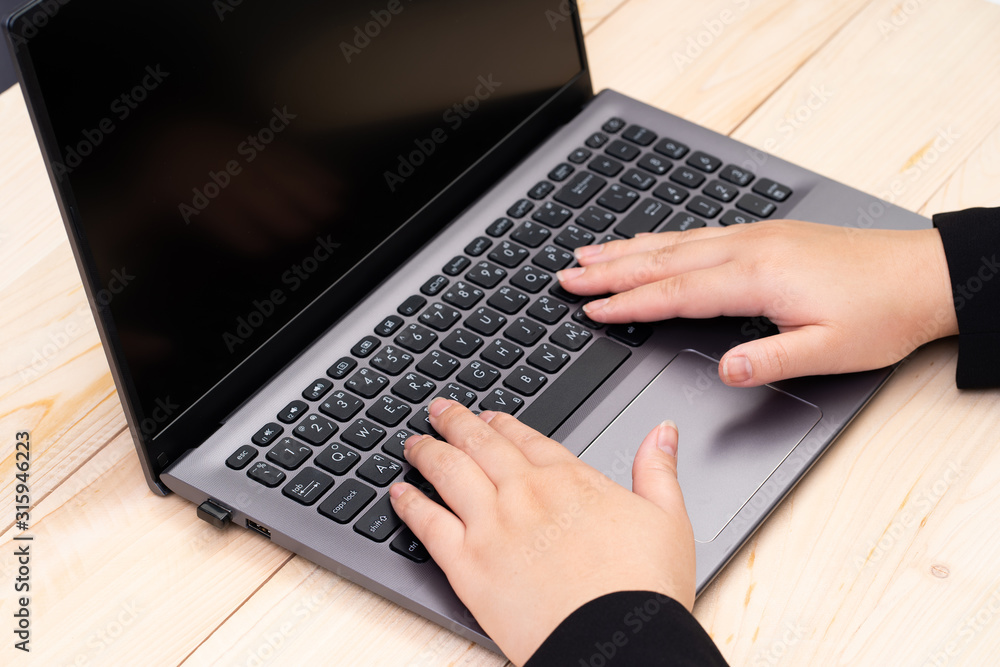 Blank black screen laptop computer with woman hands Blank black screen laptop computer with woman hands