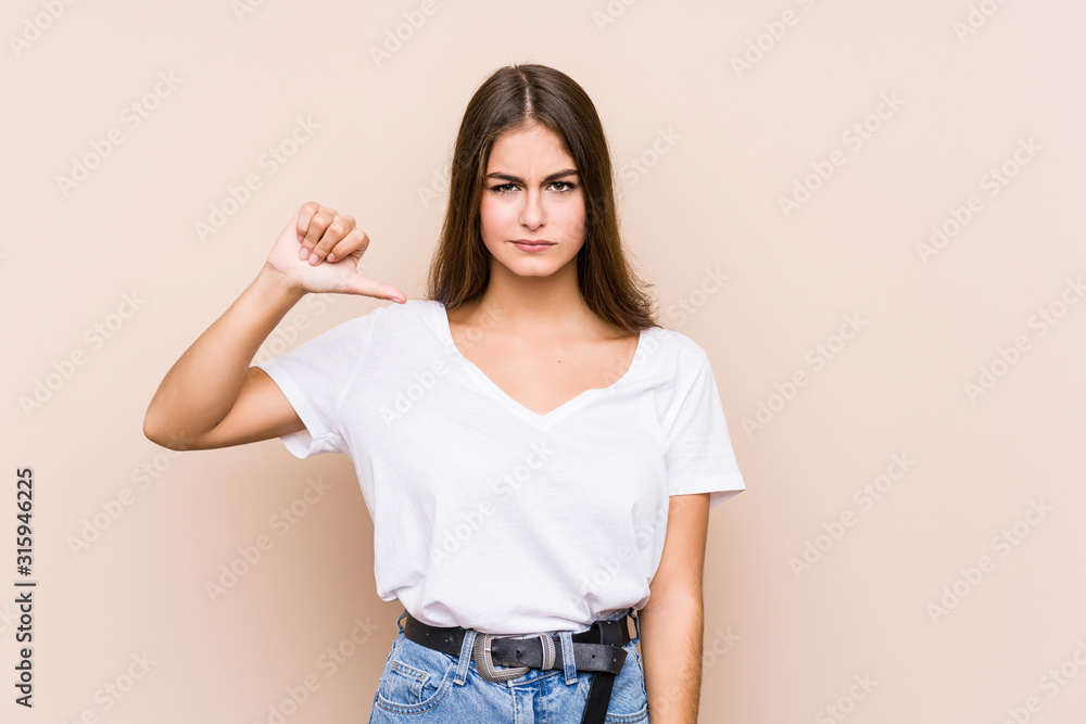 Young caucasian woman posing isolated showing a dislike gesture, thumbs down. Disagreement concept. Young caucasian woman posing isolated showing a dislike gesture, thumbs down. Disagreement concept.