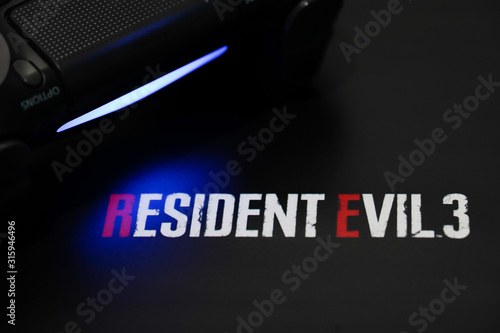 Fotografie BANGKOK,THAILAND-JANUARY 16: View of Resident Evil 3 Nemesis Remake Logo with PS4 Joystick on January 16,2020