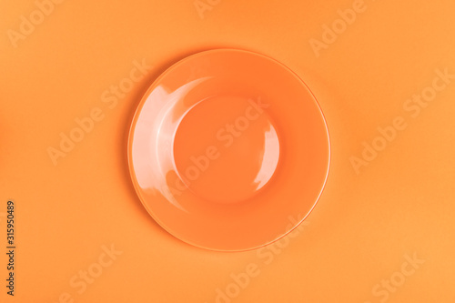 Empty orange plate on orange