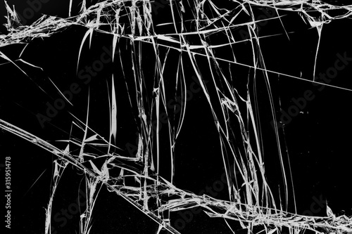 Chaotic cracks in glass on black background © maykal