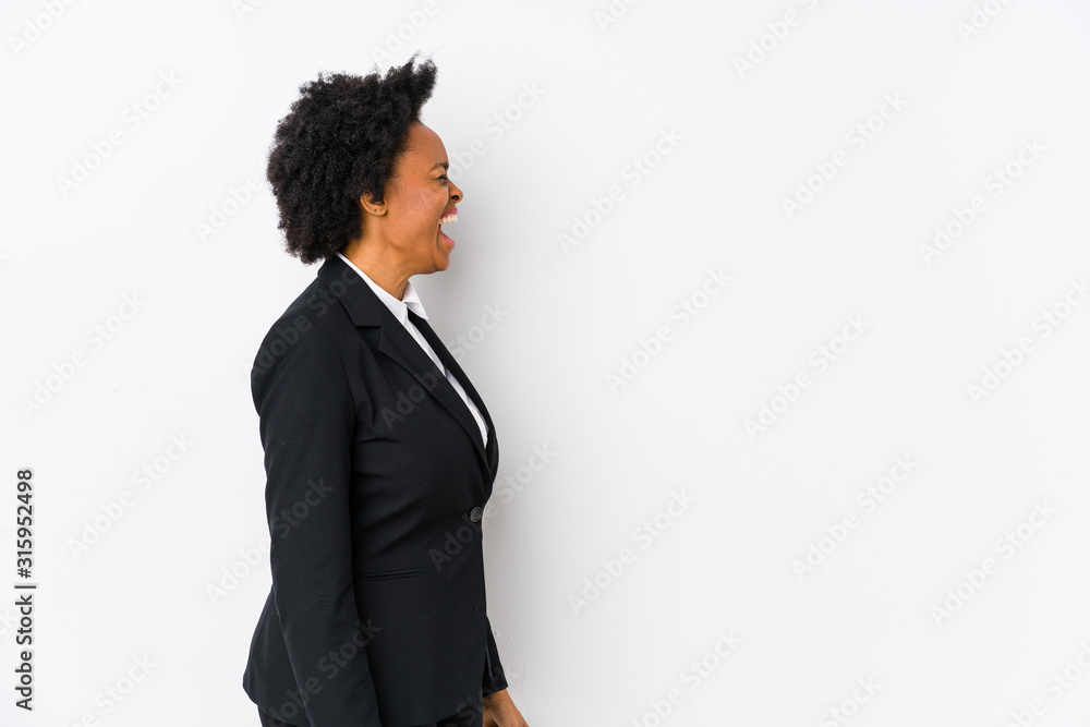 Middle aged african american business woman against a white background isolated shouting towards a copy space Middle aged african american business woman against a white background isolated shouting towards a copy space