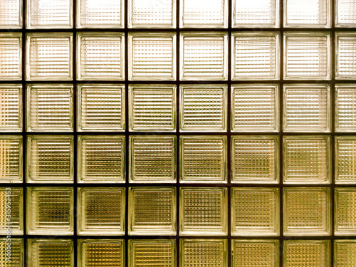 The sun light through the glass walls.Close up transparent bricks block the light to brighten the walkway.