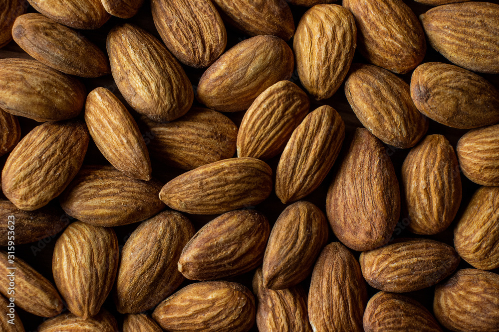Fototapeta premium Whole organic almond nuts top view