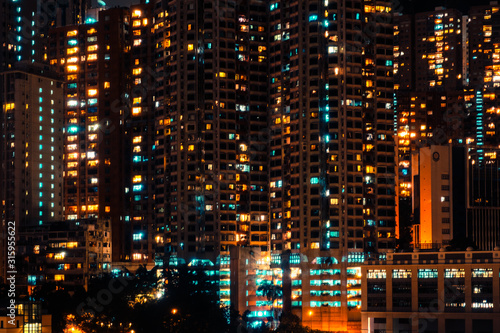 city lights of skyscraper buildings at night, downtown cityscape of hongkong at night © hanohiki