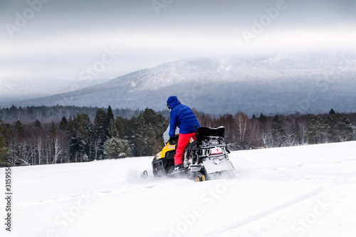 Athlete on a snowmobile. © 02irina