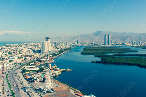 Aerial view of Ras al Khaimah (aged view), United Arab Emirates north of Dubai, looking at the city, Hajar mountains - Jebal Jais - and the Mangroves along the Corniche.