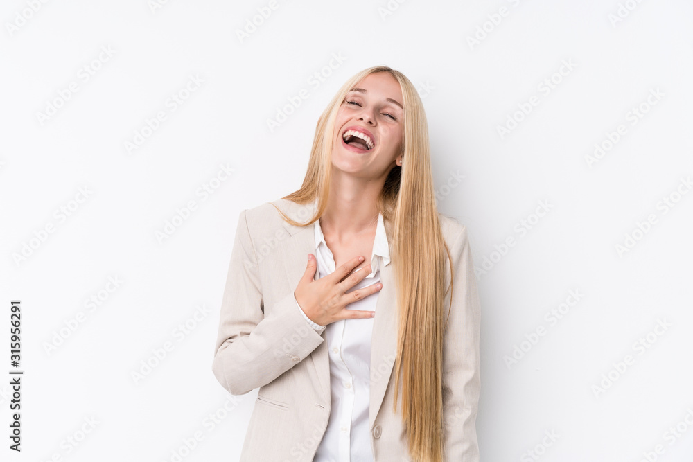 Young business blonde woman on white background laughs out loudly keeping hand on chest. Young business blonde woman on white background laughs out loudly keeping hand on chest.