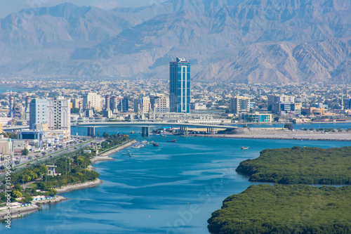 Aerial view of Ras al Khaimah, United Arab Emirates north of Dubai, looking at the city, bridge, Jebal Jais - and along the Corniche.