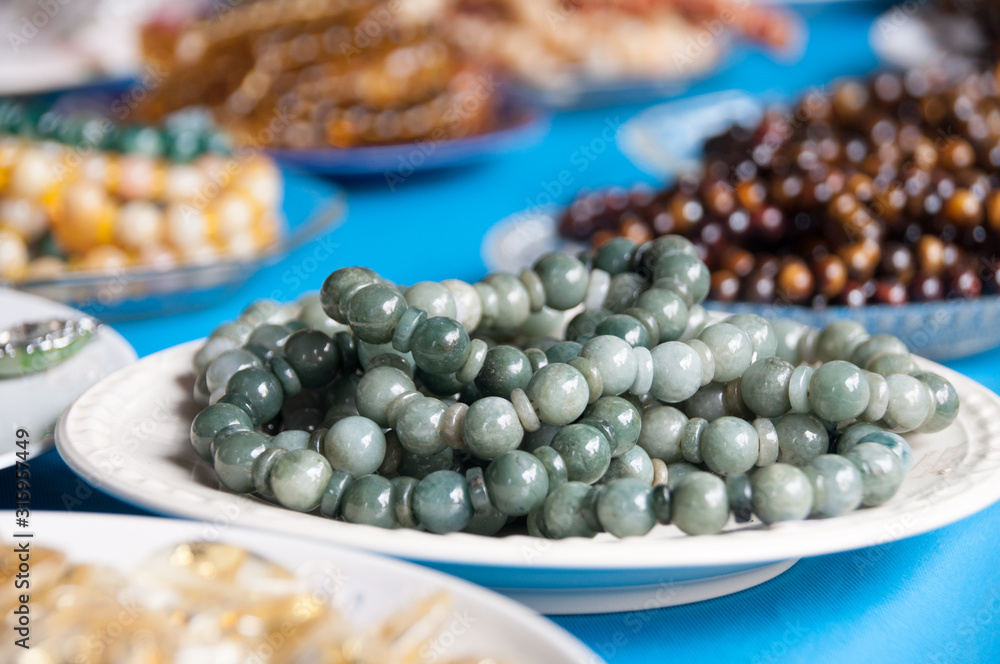 Close up Jade rosary on the white plate for sale. Close up Jade rosary on the white plate for sale.