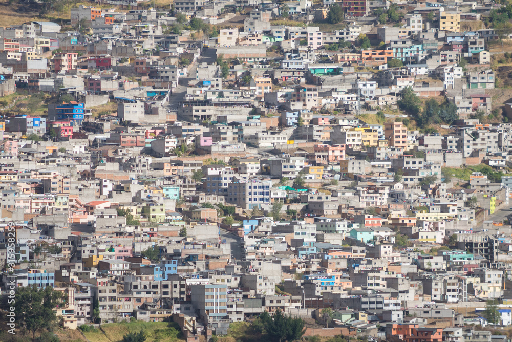 Many residential houses in Quito, Ecuador. Photo taken from a hill with telephoto lens