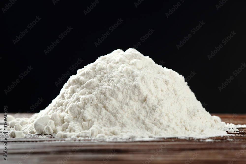 Pile of flour ay black background Pile of flour ay black background