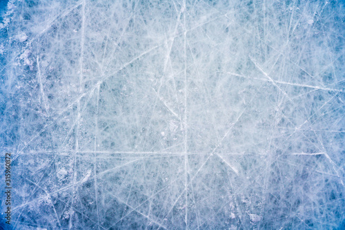 Canvas Print Ice background with marks from skating and hockey, blue texture of rink surface
