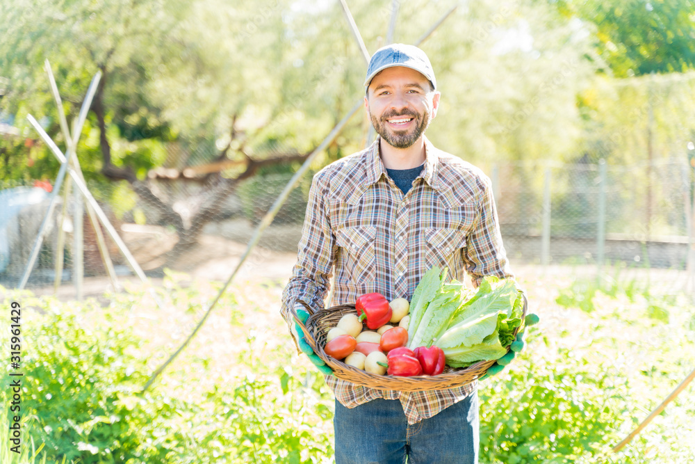 Fototapeta premium Confident Farmer With Organic Vegetables At Farm