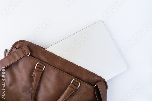 Brown business leather briefcase with notebook isolated background