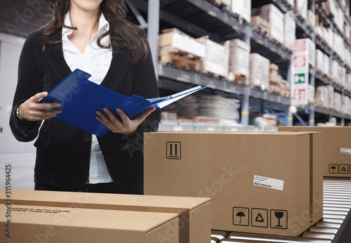 фотографія Cardboard boxes on conveyor rollers inside a warehouse ready to be shipped by co