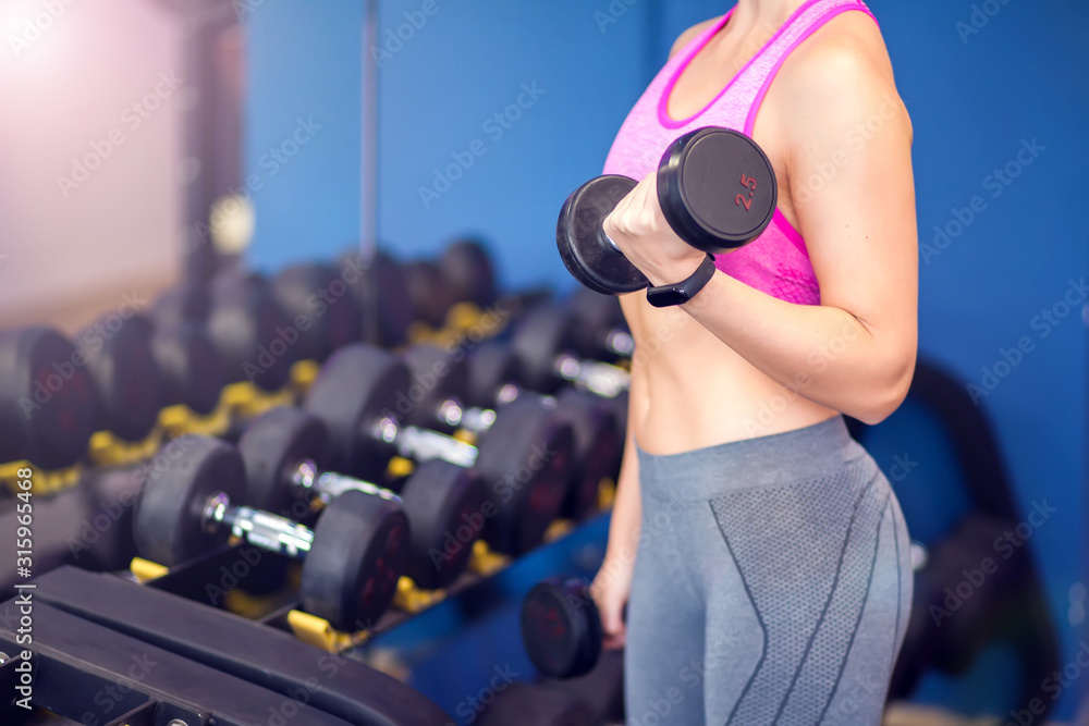Woman doing workout with dumbbells. People, fitness and health care concept Woman doing workout with dumbbells. People, fitness and health care concept