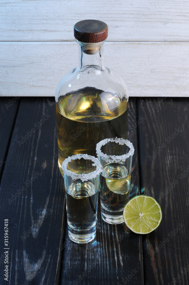 Bottle of whiskey on a wooden background.Studio photography Bottle of whiskey on a wooden background.Studio photography