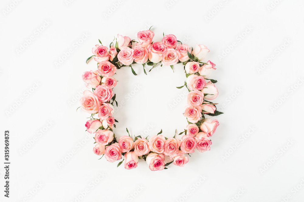 Flat lay square frame border with blank copy space mockup made of pink rose flower buds on white background. Top view floral concept.