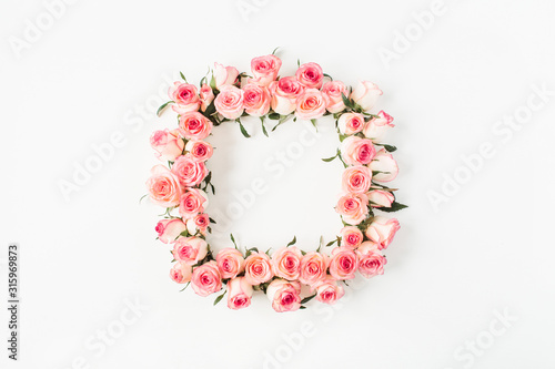 Flat lay square frame border with blank copy space mockup made of pink rose flower buds on white background. Top view floral concept.