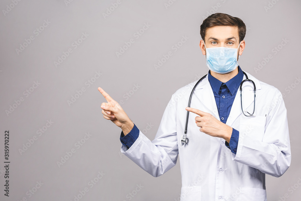 Portrait of young doctor in mask isolated on grey background. Portrait of young doctor in mask isolated on grey background.