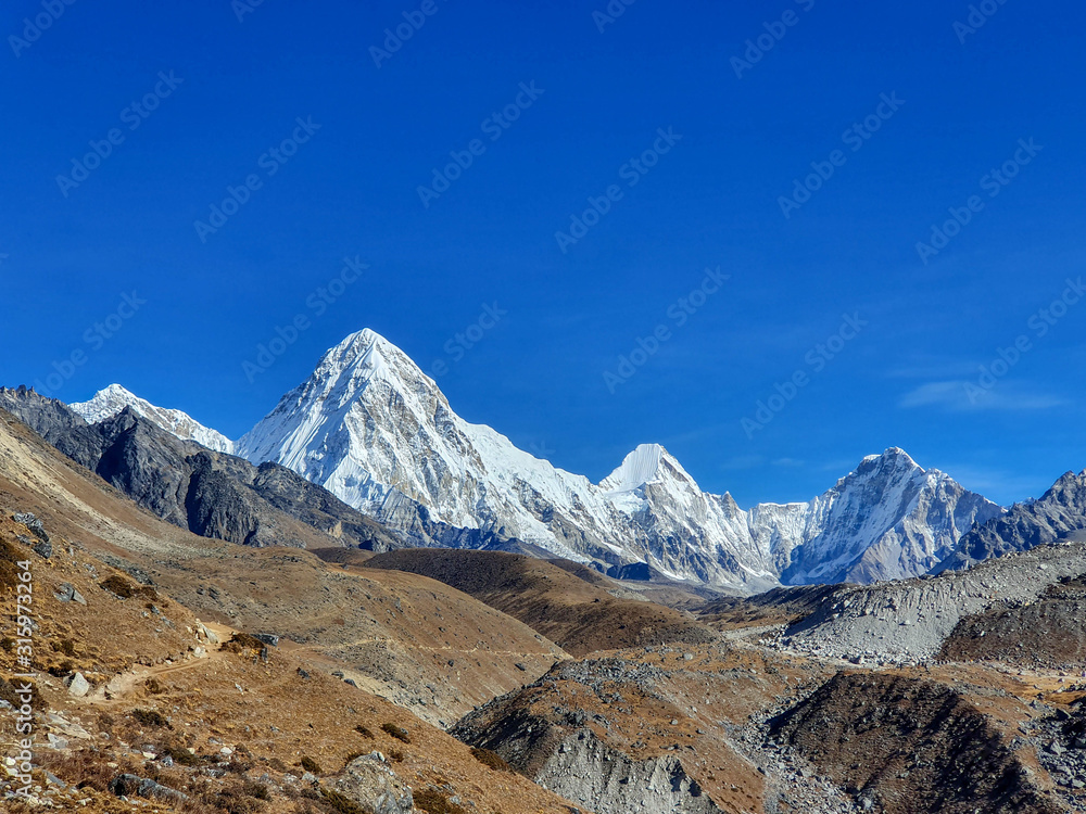 Fototapeta premium Beautiful view on Pumori mountain in the early sunny morning. Everest base camp trek: from Dzongla to Lobuche, Solokhumbu, Nepal.