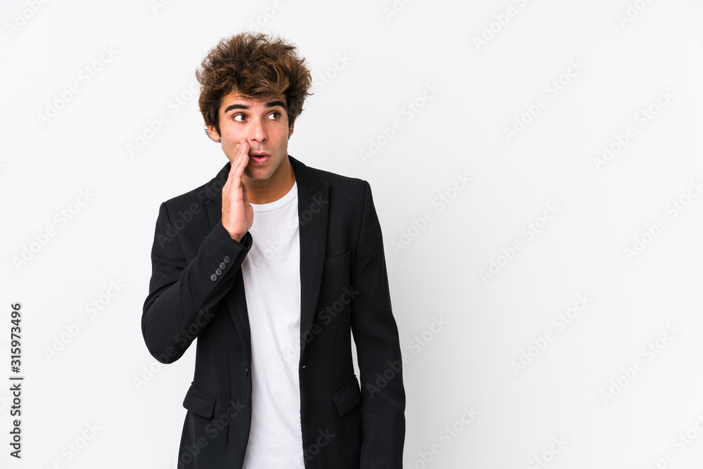Young caucasian business man against a white background isolated is saying a secret hot braking news and looking aside Young caucasian business man against a white background isolated is saying a secret hot braking news and looking aside