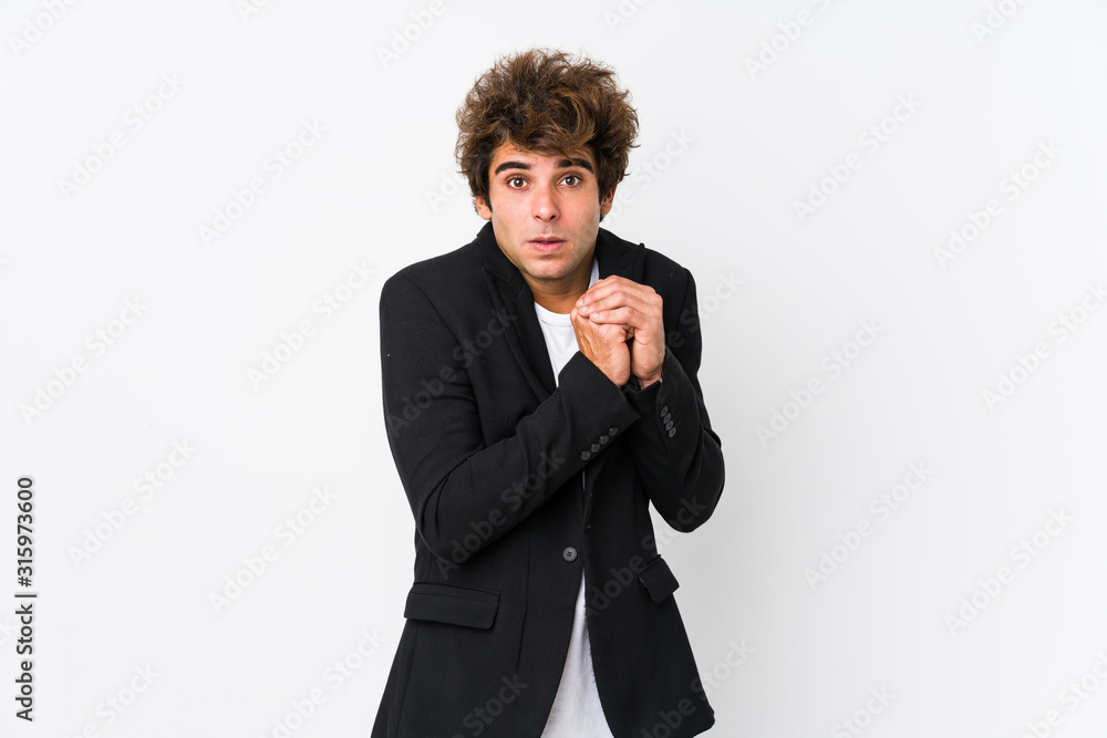 Young caucasian business man against a white background isolated scared and afraid. Young caucasian business man against a white background isolated scared and afraid.
