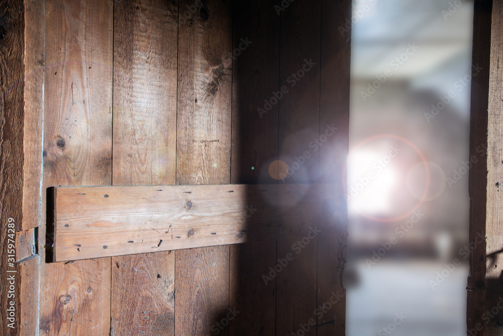 Old wooden dark abandoned attic with sunlight through the window and a open door, needs renovation Old wooden dark abandoned attic with sunlight through the window and a open door, needs renovation