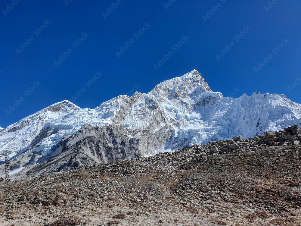 Trekkers on the way from Gorak Shep village to the legendary place - Everest base camp (EBC). Solokhumbu, Nepal, Himalayas Trekkers on the way from Gorak Shep village to the legendary place - Everest base camp (EBC). Solokhumbu, Nepal, Himalayas