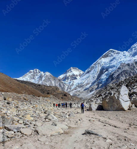 Trekkers on the way from Gorak Shep village to the legendary place - Everest base camp (EBC). Solokhumbu, Nepal, Himalayas
