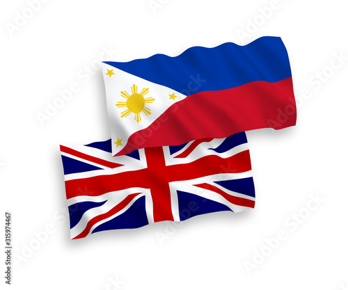 National vector fabric wave flags of Great Britain and Philippines isolated on white background. 1 to 2 proportion.