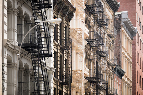 Looking up at the windows and buildings of Tribeca in New York City.