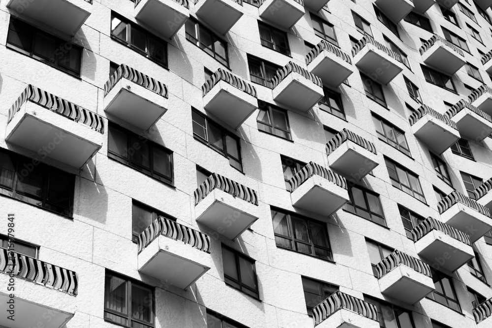 Black and white windows with small balconies. Modern living buildings