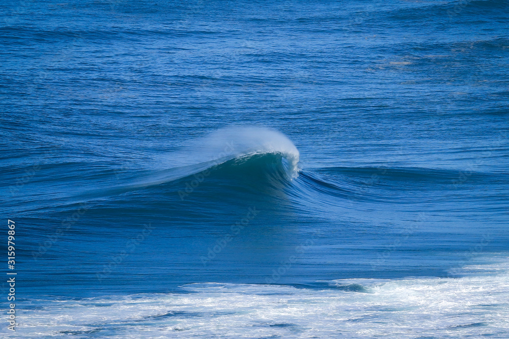 Perfect wave breaking perfectly in Nazare Portugal Perfect wave breaking perfectly in Nazare Portugal