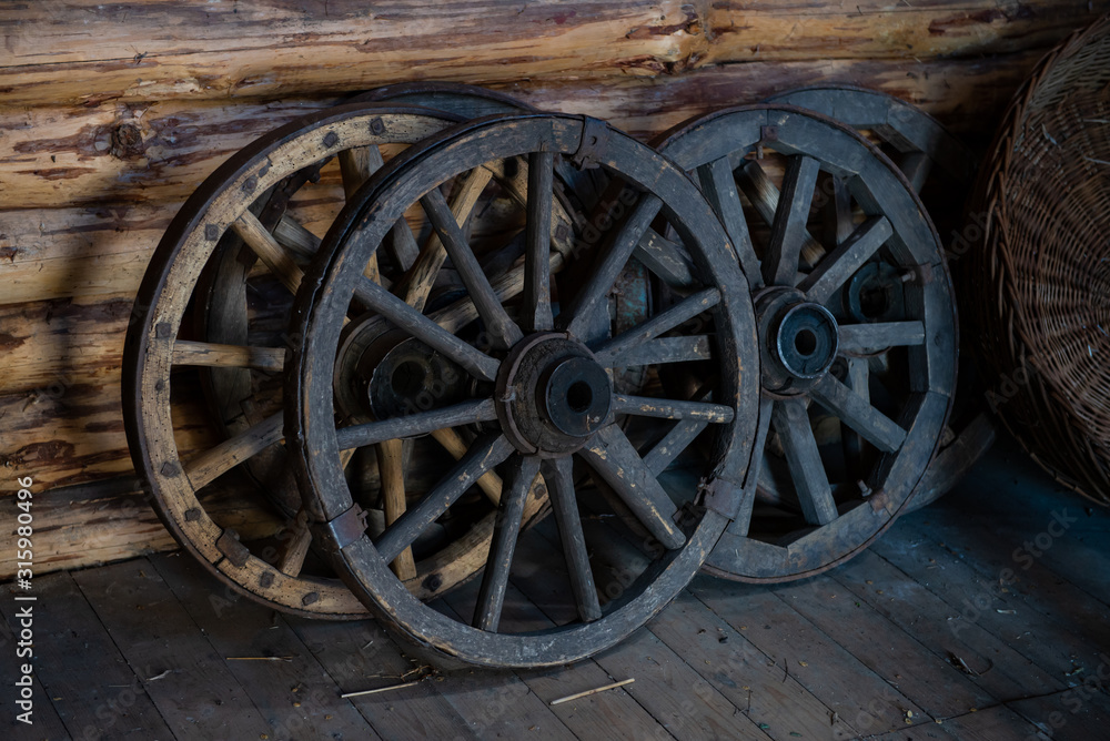 Old wooden wheels from cart ukrainian national ancient transport in barn