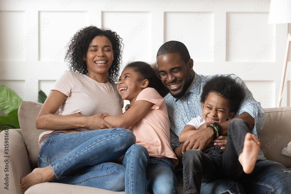 Smiling black family with kids having fun at home. Smiling black family with kids having fun at home.