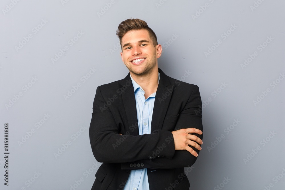 Young handsome caucasian man who feels confident, crossing arms with determination. Young handsome caucasian man who feels confident, crossing arms with determination.