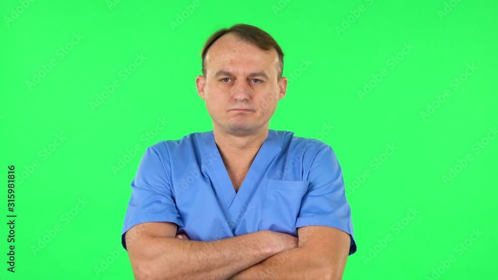 Medical man is offended and looks away . Green screen Medical man is offended and looks away . Green screen