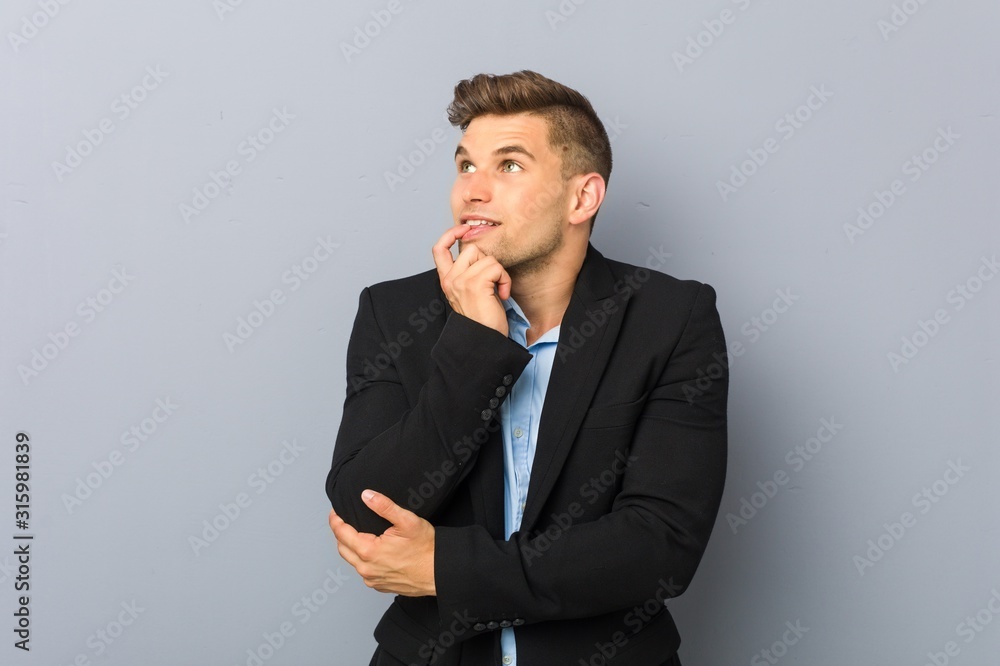 Young handsome caucasian man relaxed thinking about something looking at a copy space. Young handsome caucasian man relaxed thinking about something looking at a copy space.
