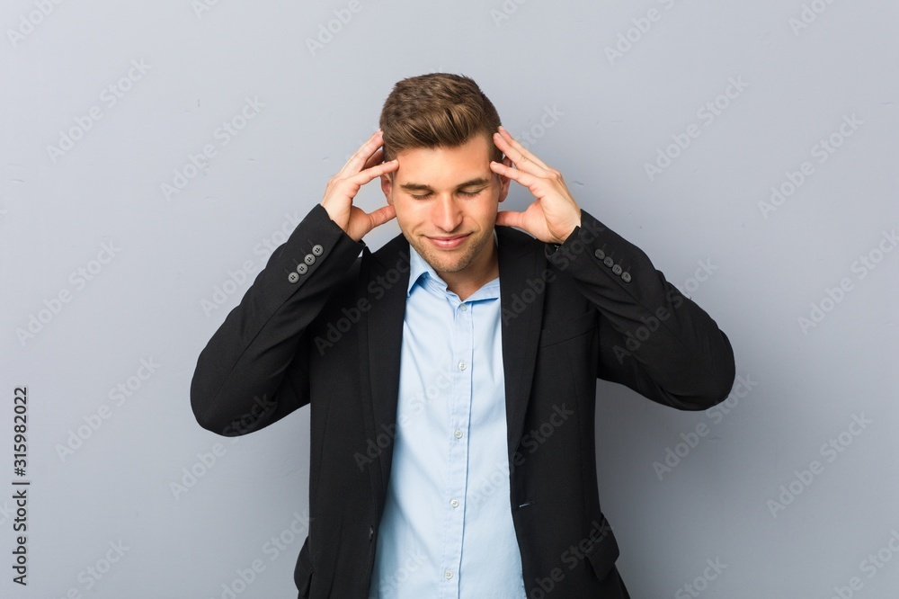 Young handsome caucasian man touching temples and having headache. Young handsome caucasian man touching temples and having headache.