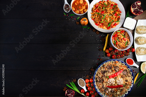 The concept of oriental cuisine. Assorted Uzbek food set, pilaf, samsa, lagman, manta, shurpa Uzbek restaurant concept, Uzbek food. Homemade Uzbek pilaf or plov from lamb served in cast iron cookware