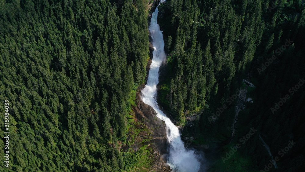 Obraz premium Aerial view of Krimml waterfall, cascades. Landscape with spruces, fir tree forest, stones, water flowing from mountains. Salzburg land, Austria.