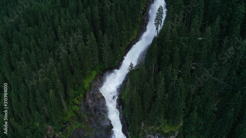 Aerial view of Krimml waterfall  cascades. Landscape with spruces  fir tree forest  stones  water flowing from mountains. Salzburg land  Austria.