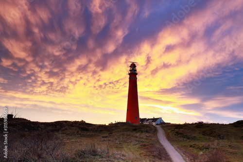 dramatic mammatus clouds over lighthouse at dawn