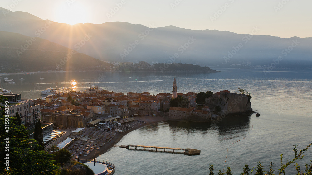 Naklejka premium The old city in Budva, Montenegro. Bay in the soft morning light of the sun.