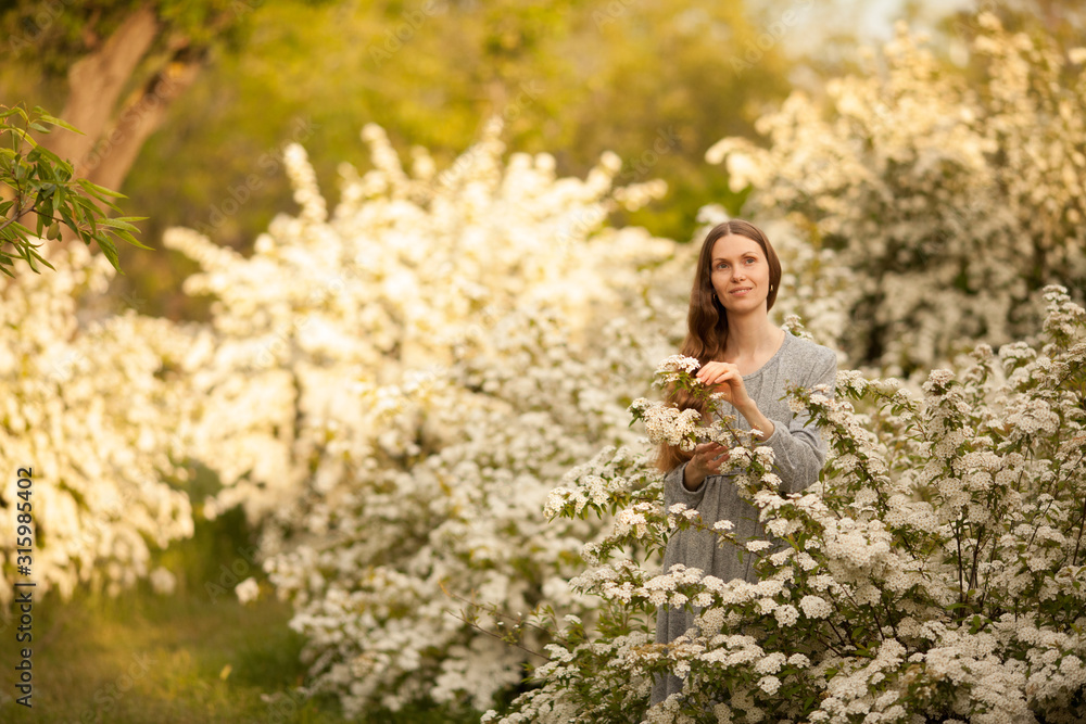 Natural beauty of a girl without makeup in the spring in a blooming garden. place for the inscription. Concept: spring. March 8. Natural beauty. Natural beauty of a girl without makeup in the spring in a blooming garden. place for the inscription. Concept: spring. March 8. Natural beauty.